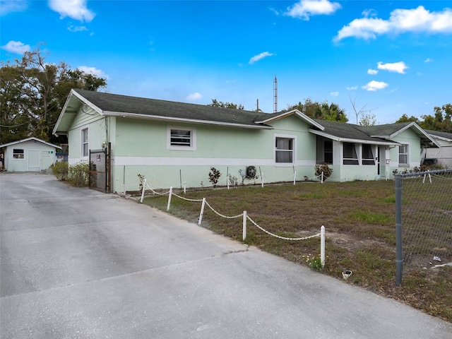 ranch-style house with fence and stucco siding