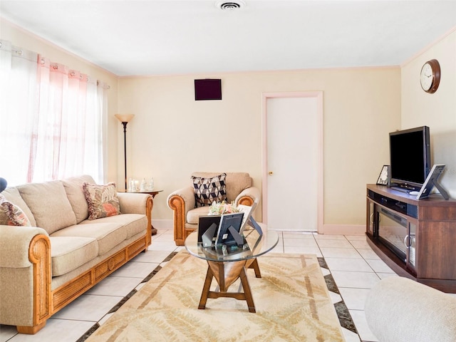 living area with light tile patterned flooring, visible vents, and baseboards