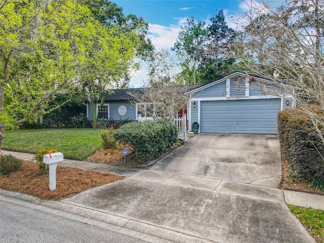 single story home featuring a front yard, driveway, and an attached garage