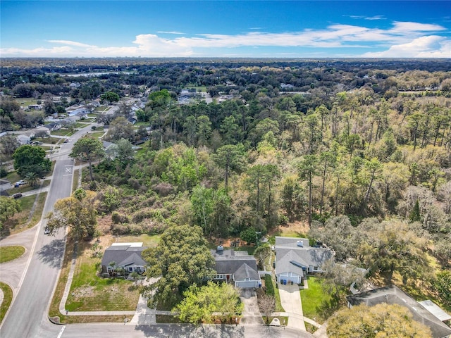 birds eye view of property with a wooded view