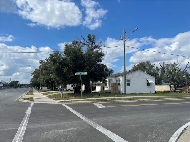 view of street with street lighting, curbs, and sidewalks