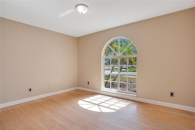 unfurnished room featuring light wood-style floors and baseboards