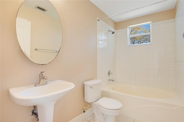 full bath with visible vents, toilet, tile patterned flooring, washtub / shower combination, and a sink