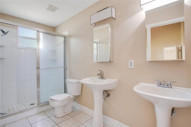 bathroom with toilet, a stall shower, tile patterned flooring, and visible vents