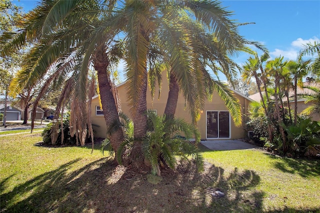 exterior space with a lawn and stucco siding