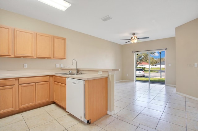 kitchen with visible vents, a peninsula, white dishwasher, light brown cabinets, and a sink