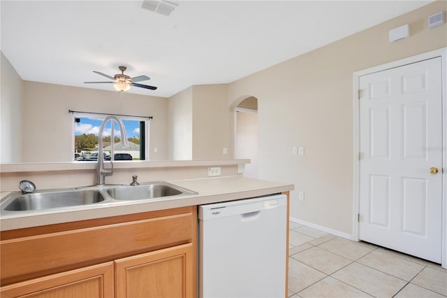 kitchen featuring visible vents, white dishwasher, a sink, and light tile patterned floors