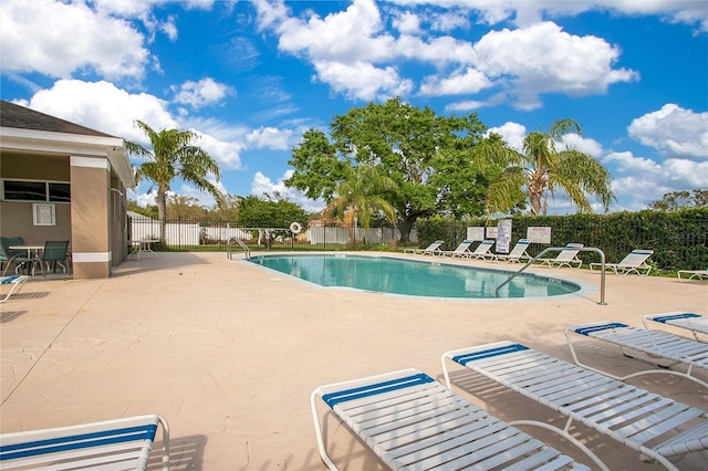 pool featuring a patio area and fence