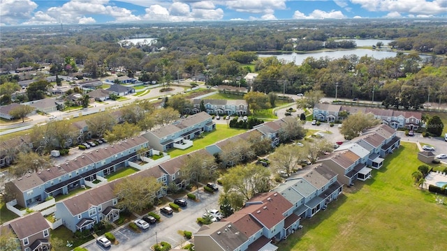 drone / aerial view featuring a water view and a residential view