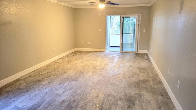 empty room featuring ceiling fan, ornamental molding, wood finished floors, and baseboards