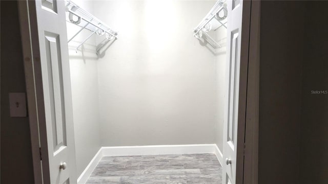 spacious closet featuring wood finished floors