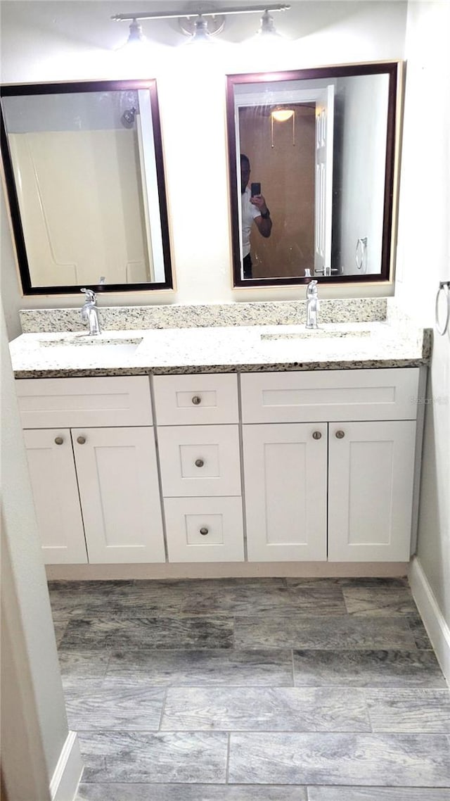 full bath featuring a sink and double vanity