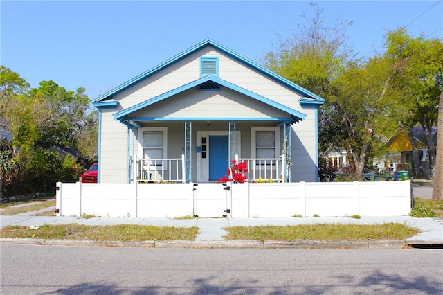 bungalow-style house featuring a fenced front yard and a porch