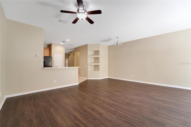 unfurnished living room with dark wood-style floors, baseboards, visible vents, and ceiling fan with notable chandelier