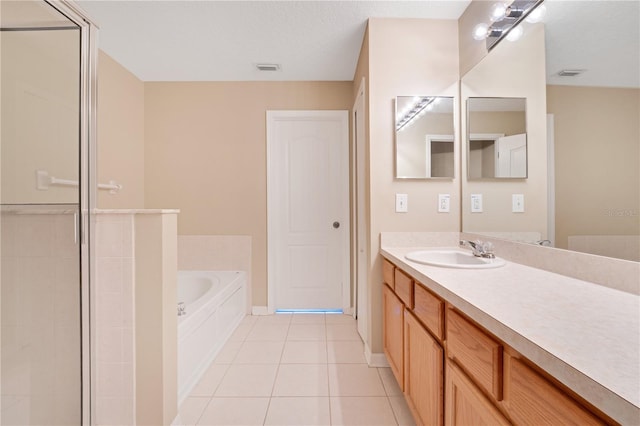 bathroom with a garden tub, tile patterned flooring, vanity, and a shower stall