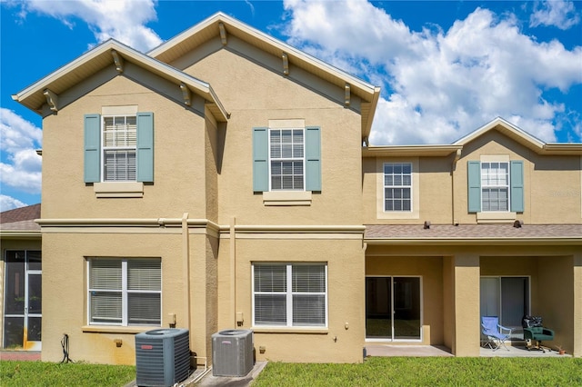 back of property featuring a patio area, cooling unit, and stucco siding