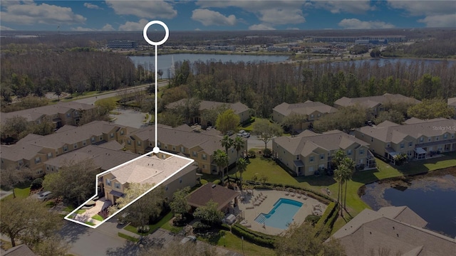 birds eye view of property with a water view and a residential view