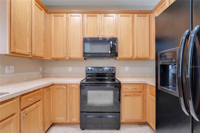 kitchen with light brown cabinets, light countertops, and black appliances