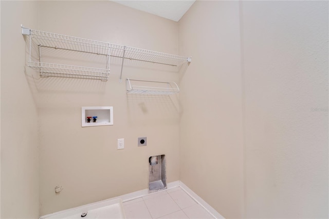 washroom with light tile patterned floors, gas dryer hookup, hookup for an electric dryer, laundry area, and washer hookup