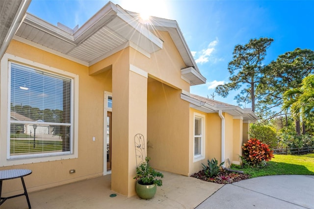 view of side of property with a patio area and stucco siding