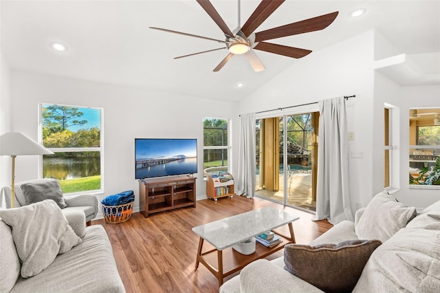 living room featuring light wood-style floors, recessed lighting, vaulted ceiling, and ceiling fan