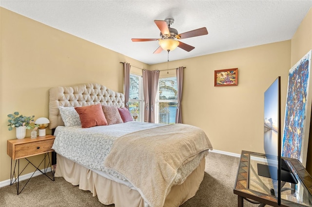 bedroom with carpet floors, baseboards, and a textured ceiling