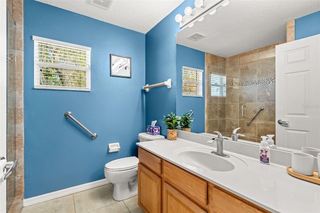 full bathroom with a textured ceiling, tile patterned flooring, vanity, visible vents, and a shower stall