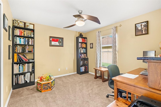 home office with light carpet, ceiling fan, and baseboards