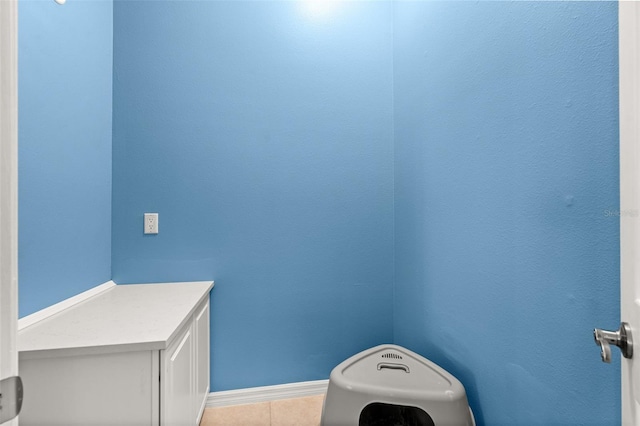 bathroom with baseboards and tile patterned floors