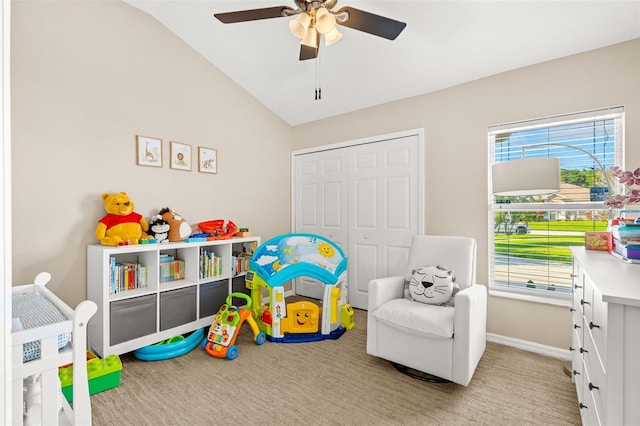 recreation room with lofted ceiling, baseboards, light colored carpet, and a healthy amount of sunlight