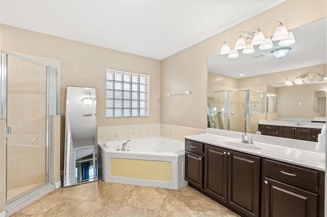 full bathroom with a stall shower, tile patterned floors, a garden tub, and vanity