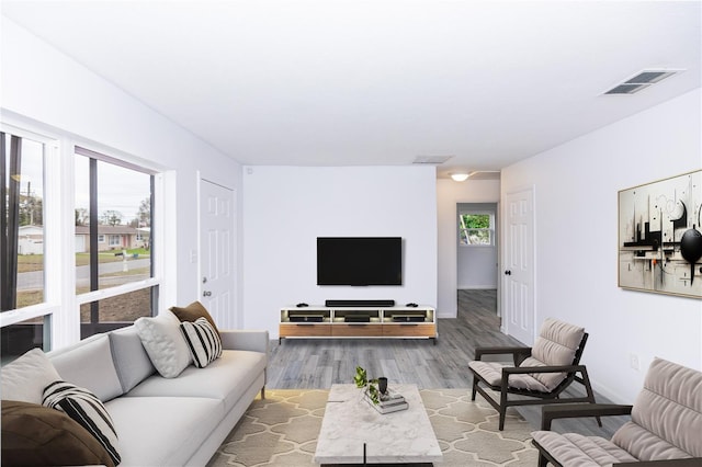 living room featuring visible vents and wood finished floors