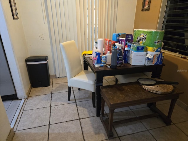 dining space featuring light tile patterned floors and baseboards