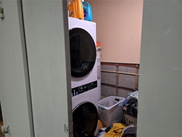 laundry area with stacked washer and dryer and laundry area