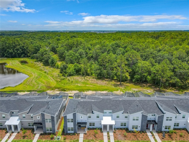 aerial view with a forest view, a water view, and a residential view