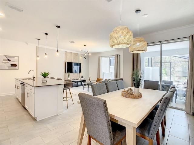 dining area featuring light tile patterned floors, visible vents, and crown molding