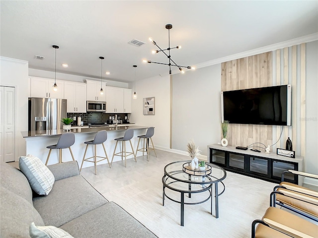 living room featuring baseboards, visible vents, crown molding, and recessed lighting