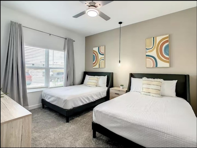 bedroom with baseboards, ceiling fan, and light colored carpet