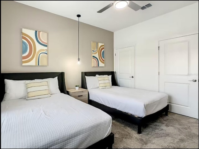 bedroom with light carpet, ceiling fan, and visible vents