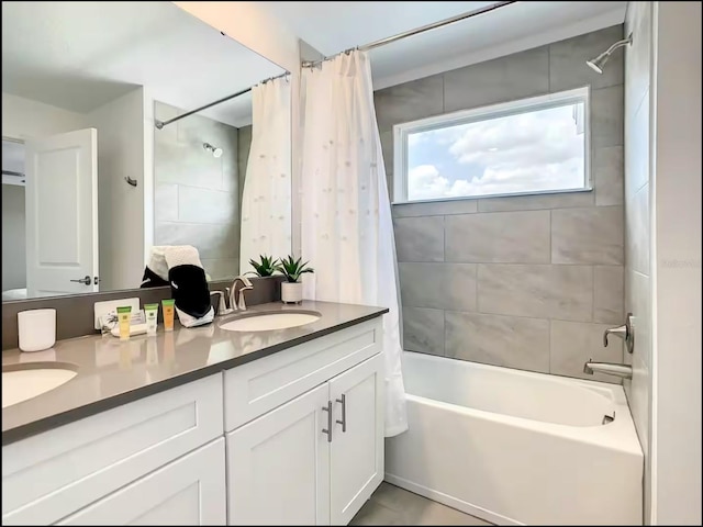 full bath with shower / bath combo, a sink, and double vanity