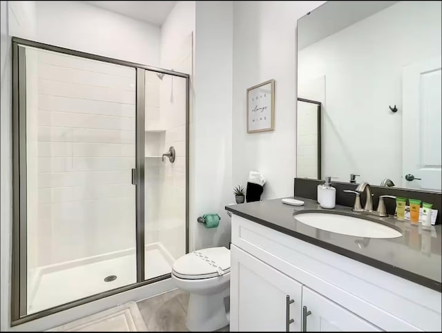 full bath with toilet, a shower stall, and vanity