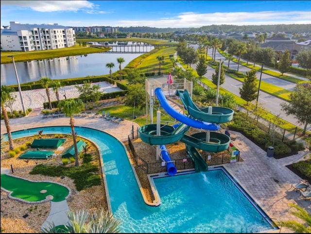 pool featuring a water view, playground community, and a water slide