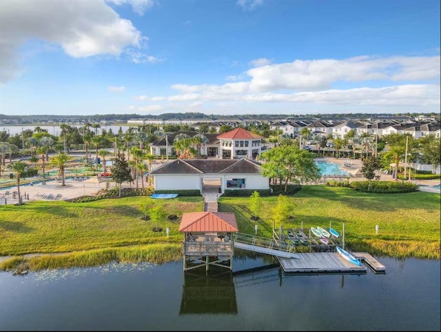 drone / aerial view featuring a residential view and a water view