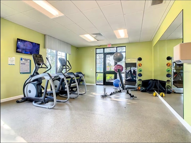 workout area featuring baseboards, visible vents, and a drop ceiling