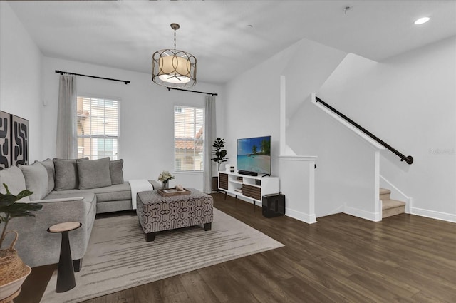 living area featuring baseboards, stairway, wood finished floors, and recessed lighting