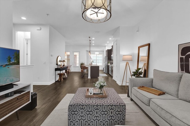 living area featuring recessed lighting, baseboards, and wood finished floors