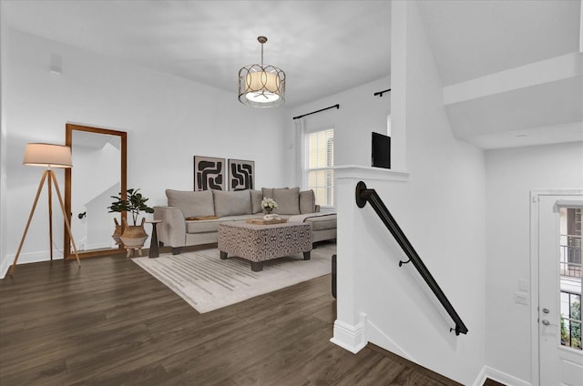 living room featuring dark wood-style flooring and baseboards