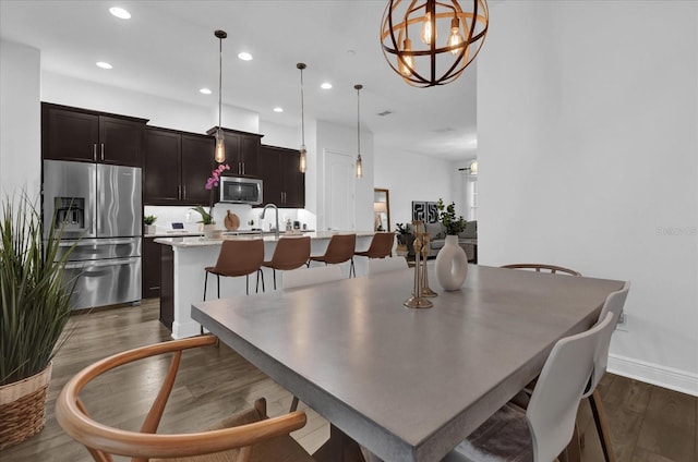 dining room featuring recessed lighting, baseboards, and wood finished floors