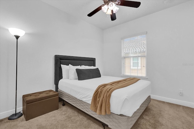 bedroom featuring carpet, baseboards, and a ceiling fan