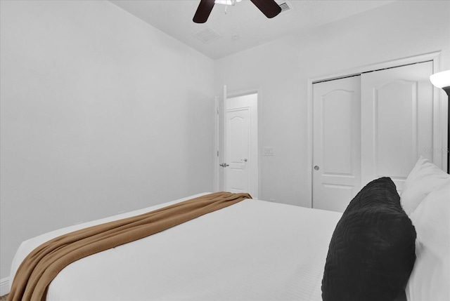 bedroom with visible vents, a ceiling fan, and a closet